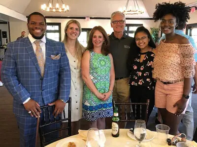 mike marion with several students and board member at golf classic