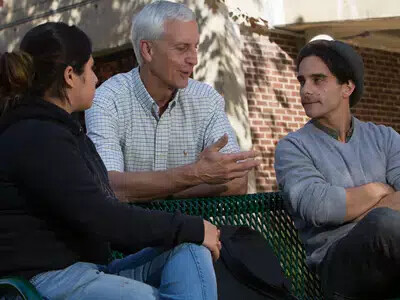 Teacher talking to two students
