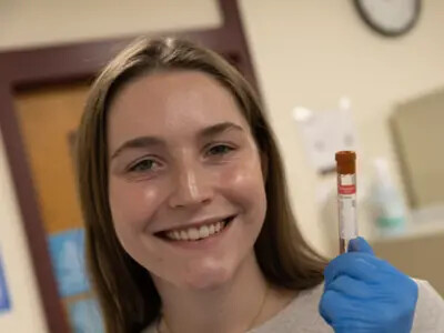 student with blood test tube