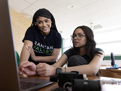 two female students working at laptop