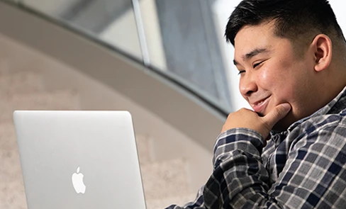 male student working on a laptop