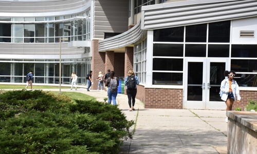 students walking outside near science building