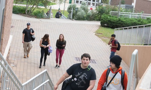 student walking up steps near bateman center