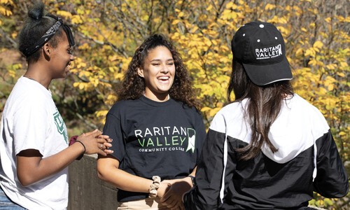 girl with rvcc t-shirt next to 2 girls with side and back to camera