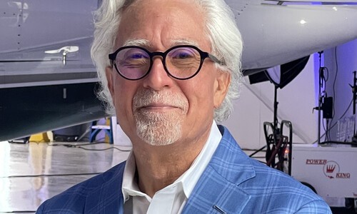 keith famie wearing glasses and light blue blazer