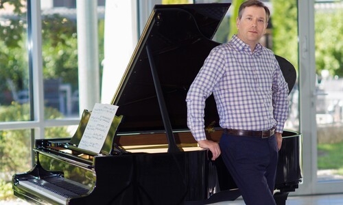 pianist morozov standing in front of piano