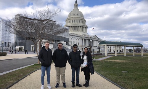 four honors college students with capitol  in background