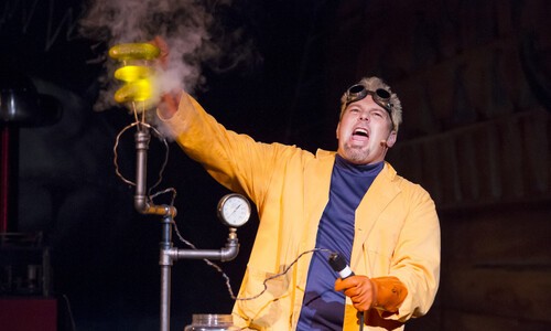 man in yellow jacket doing science experiment