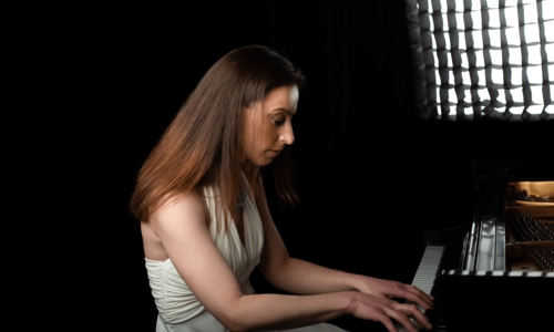 side view of anna keiserman playing piano