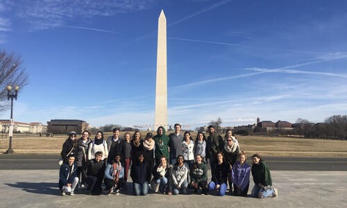 group outside in front of monument