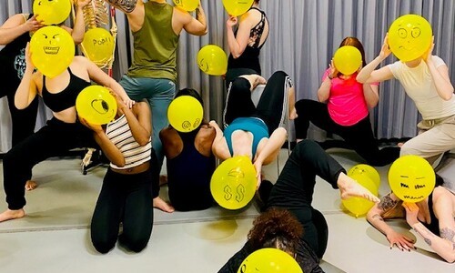 dancers with yellow face balloons