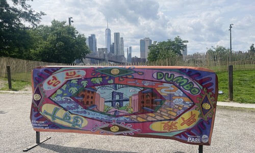 draped artwork with city behind it