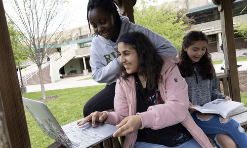 3 female students studying in gazebo outside