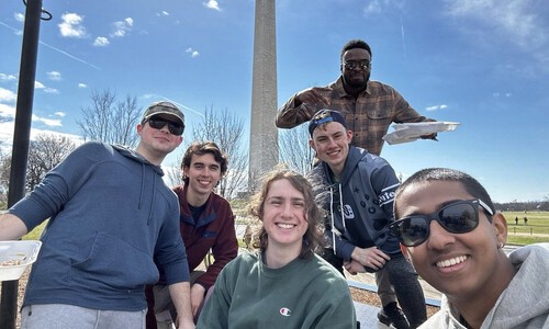 students outside with washington monument in background