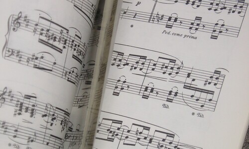 pieces of sheet music in motion