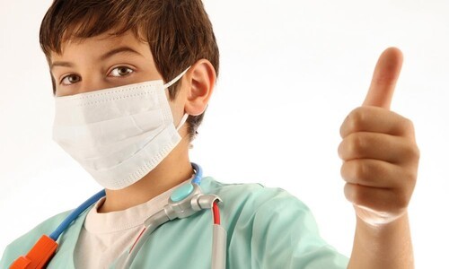 masked child doctor with thumb's up