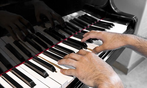 male playing piano