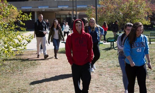 group of students in sweatshirts walking outside