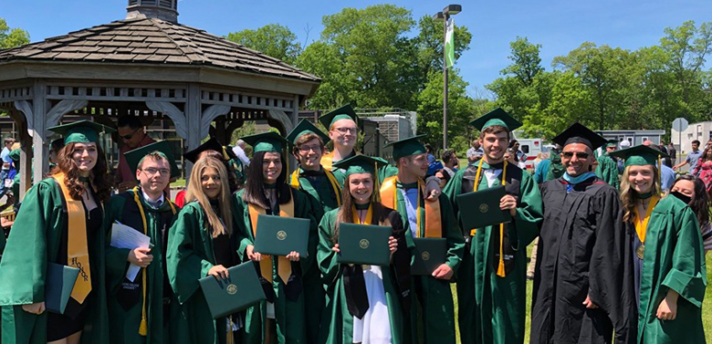 group of graduates in cap and gown