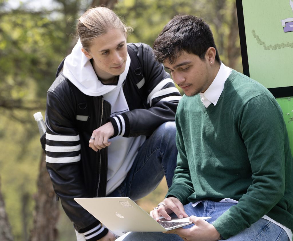 Two students looking at a book