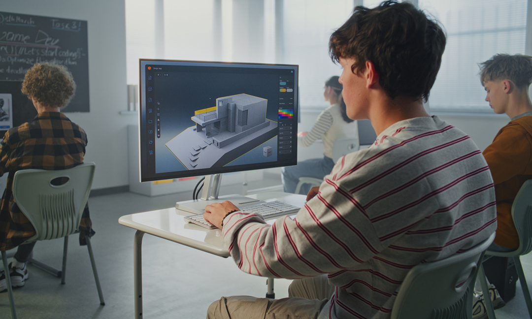 Young Man with Dark Hair Concentrates on 3D House Design at Computer in Classroom. Architectural Visualization, Creative Education. Concept of Digital Skills and Innovative Technologies. Static Shot.