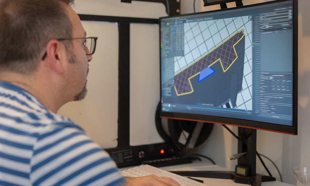 Engineer making a digital model of a machine part for 3D printing