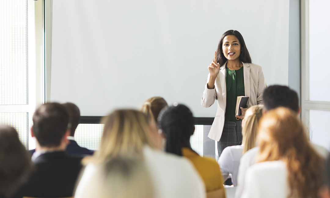 Businesswoman of Indian descent speaking at a seminar