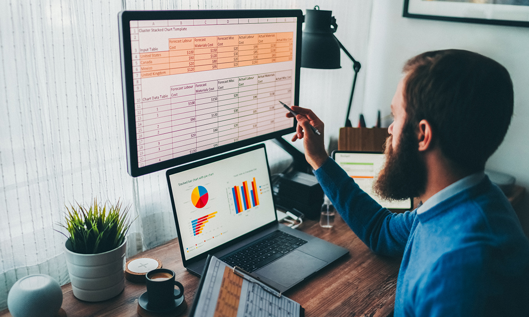 Man working on excel spreadsheets