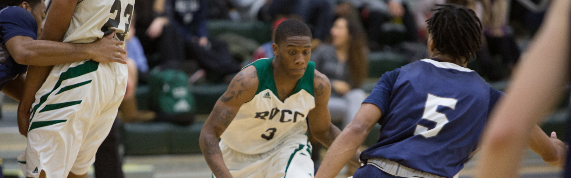 Image of the RVCC men's basketball team playing a conference game.