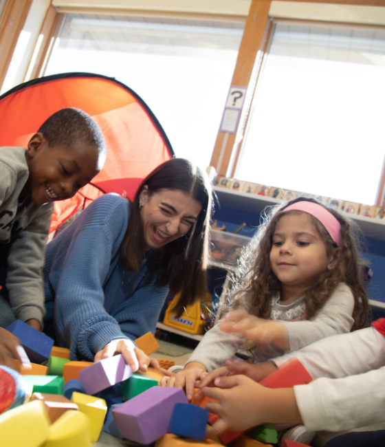 Image of a teacher and two students doing an activity.