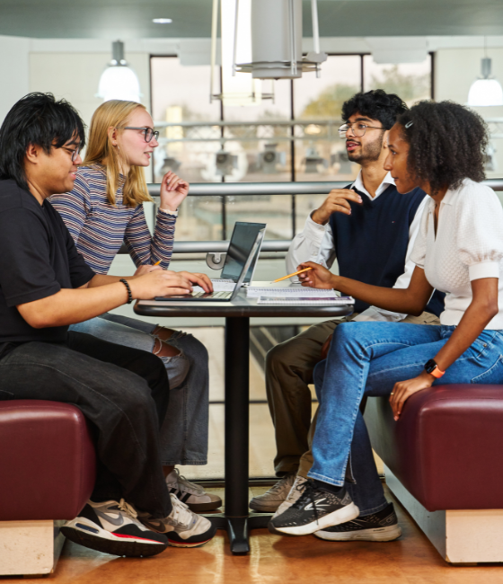 Image of four RVCC students sitting at a table on the upper floor of the cafeteria.