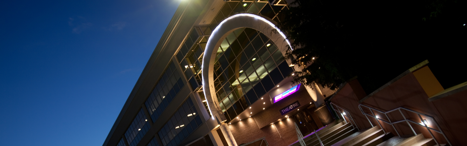 Image of the entrance to the Theatre at RVCC at night.