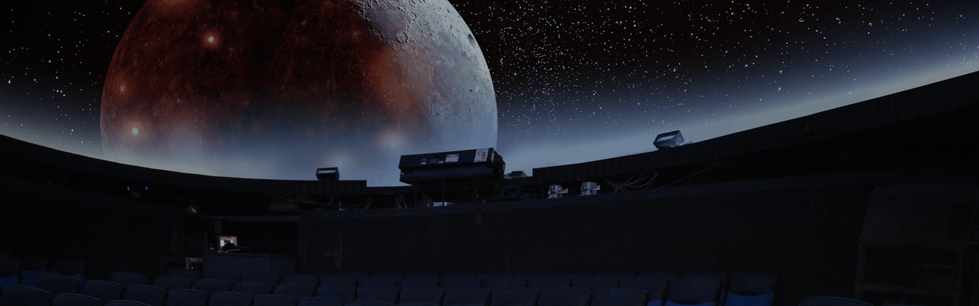 An image of the RVCC Planetarium interior with a photo of the Moon being projected.