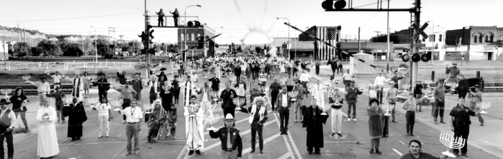 enduring tension event graphic - people in street holding up menorahs